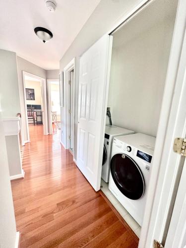 a laundry room with a washer and dryer in it at Modern Home in Sterling in Sterling