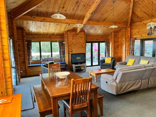 a living room with a couch and a table at Alpine on Oregon in Hanmer Springs