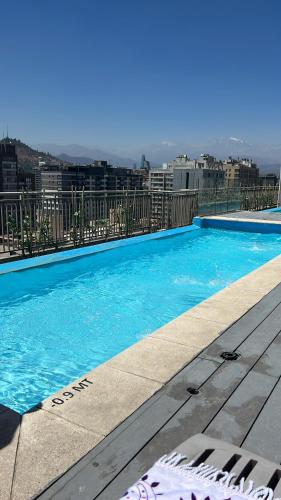 a large blue swimming pool on top of a building at Pauwla in Santiago