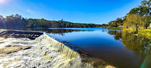 a body of water with a retaining wall at Country Style Holiday Park in Stanthorpe