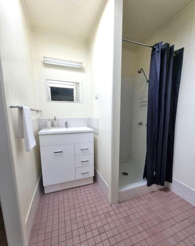 a bathroom with a sink and a shower at Country Style Holiday Park in Stanthorpe