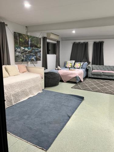 a living room with two beds and a couch at Kirwan RetreatTownsville in Ross River