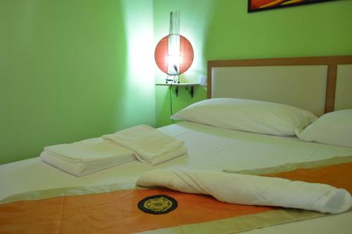 two beds in a room with two white pillows at Butterfly House Bed & Breakfast in Alghero