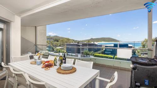 a dining room with a table and a view of the ocean at Solaris in Fingal Bay