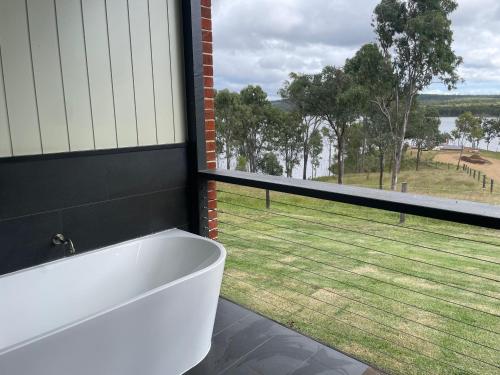 a bath tub in a bathroom with a large window at Dusty Hill Vineyard - Moffatdale in Moffatdale