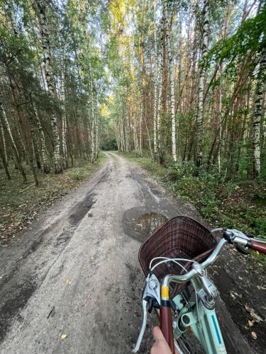 a person riding a bike down a dirt road at Sielski Zaułek Guciów u Dorotki -Basen,Jacuzzi,Sauna in Guciów