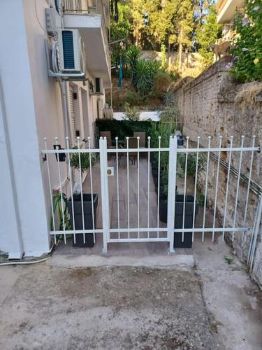 a white gate in front of a building at fotinoula1975 in Agios Rokkos