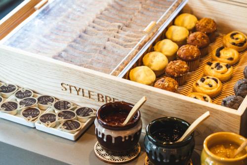 a display of various types of donuts in a bakery at KAYA Kyoto Nijo Castle, BW Signature Collection by Best Western in Kyoto