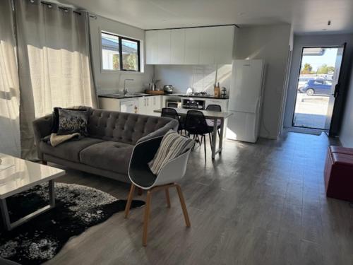 a living room with a couch and a table and a kitchen at 87 on FIFTH Ave in Hamilton