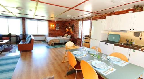 a kitchen and living room with a table and chairs at Loft at Ruutin Kartano in Laihia