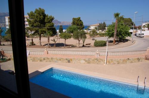 a swimming pool with a view of a street at O Sole Mio in Albir