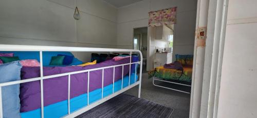 a bedroom with two bunk beds and a mirror at Golden Mount Rest Townside in Mount Morgan