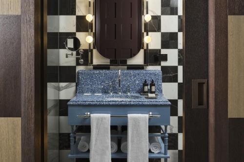 a bathroom with a blue sink and a mirror at W Budapest in Budapest