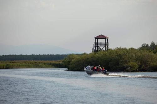 a group of people on a boat in the water at Riverside Cottage Poti in Poti