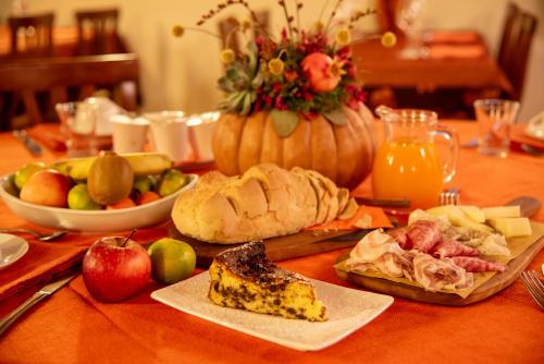 a table topped with food and a pumpkin and fruit at Agri-alloggio le Poscole Al Canton in Castelgomberto
