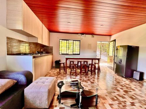 a living room with a table and a kitchen at El Diamante - Finca Privada con Piscina Barbosa in Barbosa