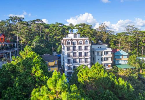 a building on top of a hill with trees at TP Dalat Hotel in Da Lat