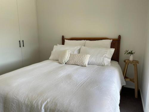 a white bed with white sheets and pillows at Kurraba - Family friendly country escape with pool in Kangaroo Valley