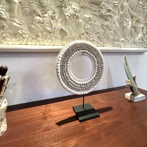 a table with a sculpture and a white wall at Villa Sinergi 2BR Tranquil Villa in Seminyak in Seminyak