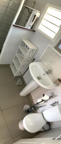 a bathroom with two toilets and a sink at Gite Le Panoramique in Dumbéa