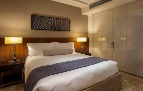 a bedroom with a large bed and two lamps at InterContinental Residence Suites Dubai Festival City by IHG in Dubai