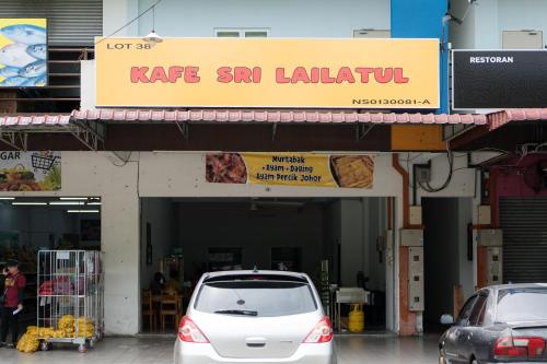 a white car parked in front of a restaurant at LumaNest Senawang in Seremban