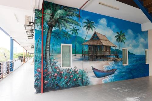 a mural of a beach with a house and a hammock at LumaNest Senawang in Seremban
