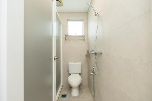 a bathroom with a toilet and a window at LumaNest Senawang in Seremban
