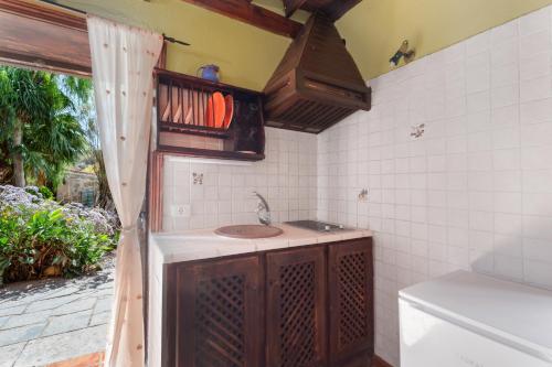 a small kitchen with a sink and a window at La Venta in Las Vegas