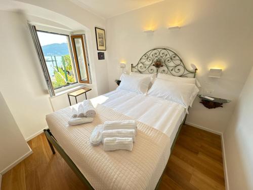 a bedroom with a white bed with towels on it at La Casa Rotonda in Portovenere