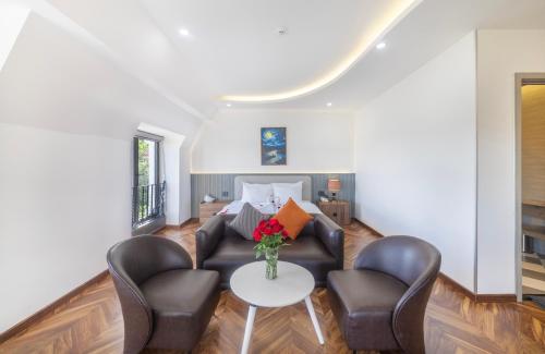 a living room with two chairs and a table at TP Dalat Hotel in Da Lat