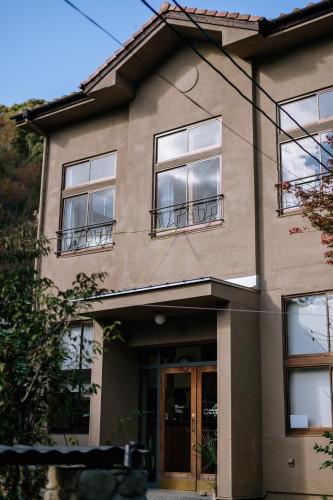 a house with windows and a door at 紅花舎 koukasha in Yamaguchi