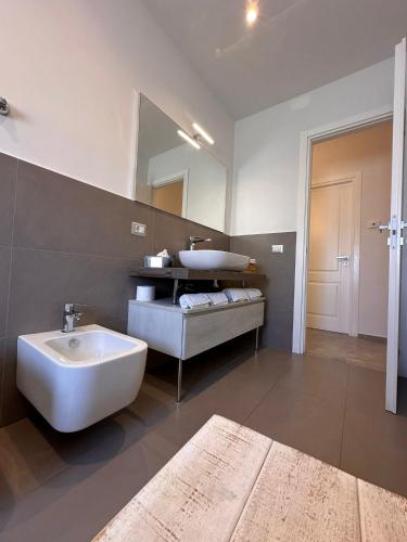 a bathroom with a sink and a tub and a mirror at Luxury Sea House in Trapani