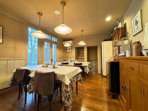 a dining room with two tables in a kitchen at Country Inn Orchard House in Hokuto
