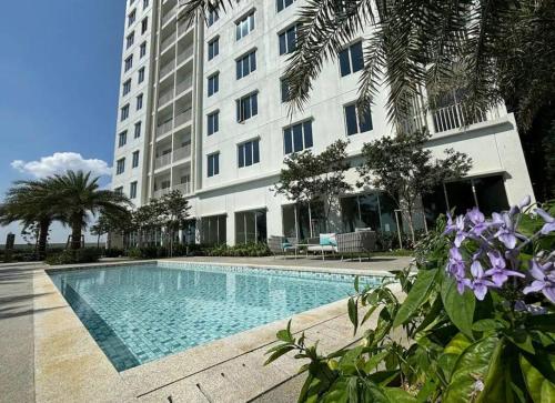a swimming pool in front of a large building at Serene Stay in Klang, Malaysia in Klang