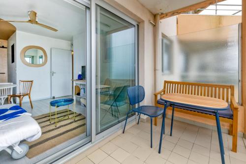 a room with a bed and a table and chairs at Appartement front de mer - Terrasse in Pornichet
