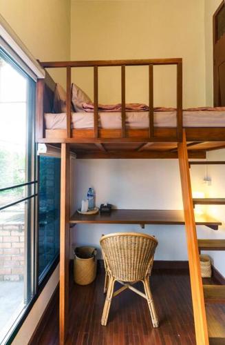 a room with two bunk beds and a chair at SOLO - Fong Lee CC Lampang Walking Street in Lampang