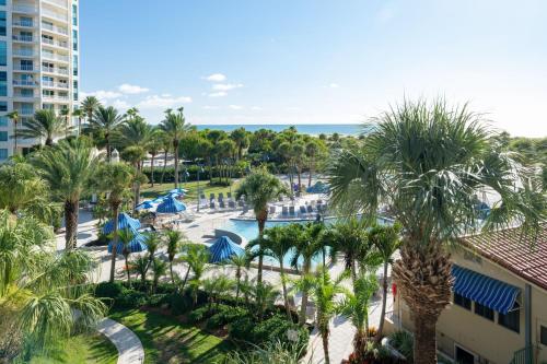 an aerial view of a resort with palm trees and a pool at Clearwater Beach Sheraton Resort on Sand Key in Clearwater Beach