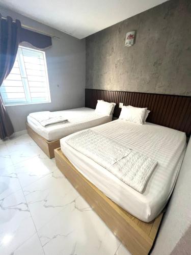 Hoang Ngan 2 Hotel - TP. Vinhにあるベッド