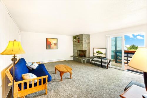 a living room with a blue couch and a fireplace at High Dunes Condos in Ocean Shores