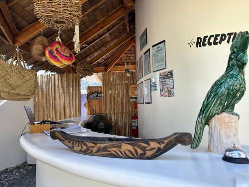 a bird statue sitting on a counter in a room at Parrots Boutique Resort in San Vicente