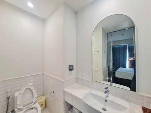 a bathroom with a toilet and a sink and a mirror at Hillside apartment sunset town city in Phu Quoc