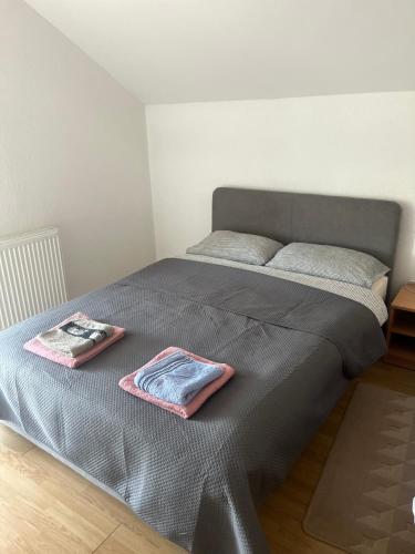 a bed with two folded towels on top of it at Prenociste Denis in Velika