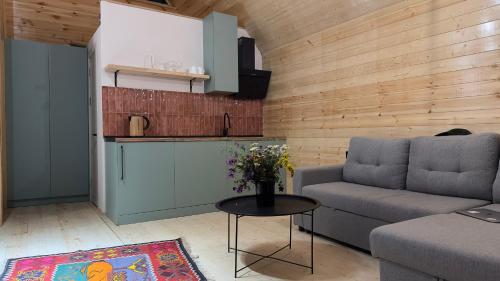 a living room with a couch and a table at Cozy Wooden House near Gudauri in Gudauri
