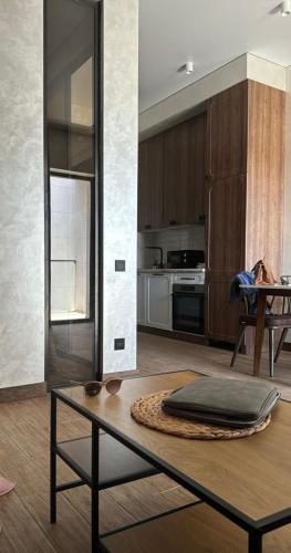 a living room with a table and a kitchen at Park Residents Seabreeze in Bilgah