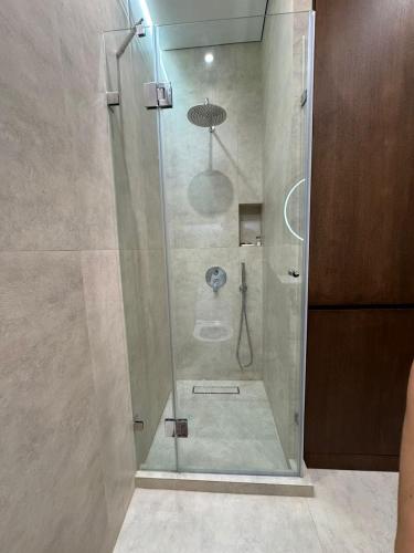 una ducha con puerta de cristal en un baño en Park Residents Seabreeze, en Bilgah