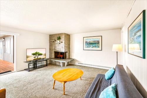 a living room with a couch and a fireplace at High Dunes Condos in Ocean Shores