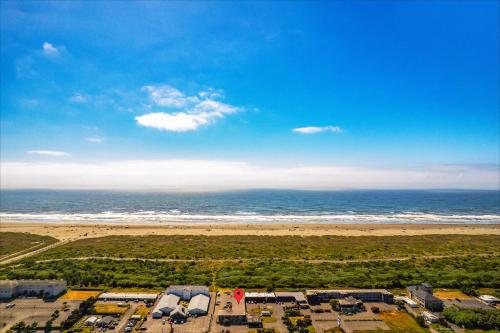 an aerial view of a beach and the ocean at High Dunes Condos in Ocean Shores