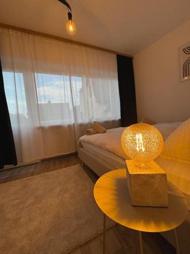 a bedroom with a bed and a table with a lamp at Gemütliche Unterkunft Bad Steben - Ferienhaus Maria in Bad Steben