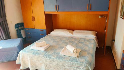 a bedroom with a bed with two towels on it at al castello in Tarquinia